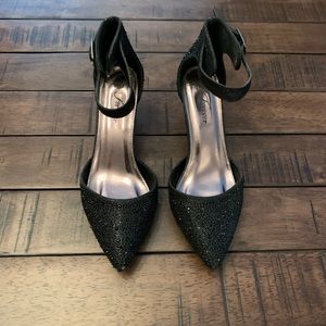 Black rhinestone covered low heeled pumps